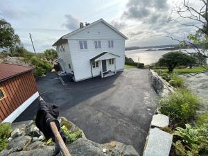 a white house on the side of a road at Sea View apartment in Askøy