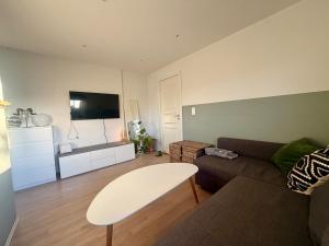 a living room with a couch and a table at Sea View apartment in Askøy