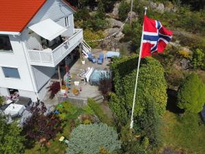 an aerial view of a house with a flag at Sea View apartment in Askøy +10 photos