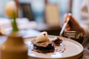 a plate of food on a table with a fork at The Crown, Bildeston in Bildeston