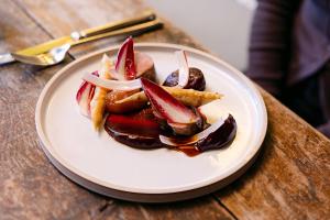 a plate of food on a wooden table at The Crown, Bildeston in Bildeston