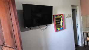 a flat screen tv hanging on a wall at Pousada Princesa da Serra in Serra do Cipo