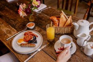 a table with a breakfast plate of eggs and toast at The Crown, Bildeston in Bildeston