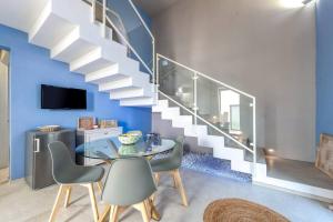 a dining room with a glass table and stairs at Corte Piri in Tricase