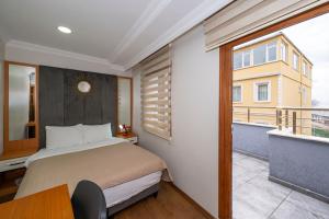 a bedroom with a bed and a balcony at Aras Life Hotel in Istanbul