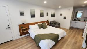 a bedroom with a large bed and a couch at #3 Hygge Hus Hotel - King Suite Connectable in Andrews