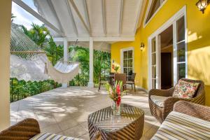 a patio with chairs and a table and a hammock at Caribbean Hill Villas in Cocles