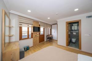 a room with a bed and a television and a table at Aras Life Hotel in Istanbul