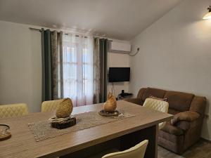a living room with a table and a couch at Apartments Nadja in Kotor