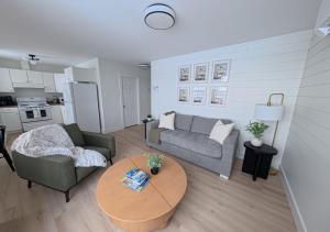 a living room with a couch and a table at Saltwater Steeple in Port Saunders