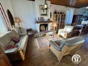 a living room with couches and a fireplace at La maison in Davejean