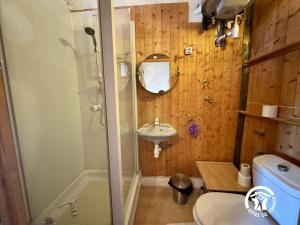 a bathroom with a shower and a sink and a toilet at La maison in Davejean +22 photos