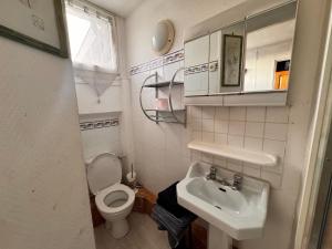 a small bathroom with a toilet and a sink at La cachette du Beffroi - Appt 30 m² centre Arras in Arras