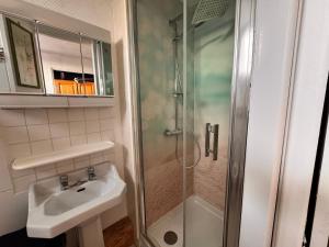 a bathroom with a shower and a sink at La cachette du Beffroi - Appt 30 m² centre Arras in Arras +2 photos