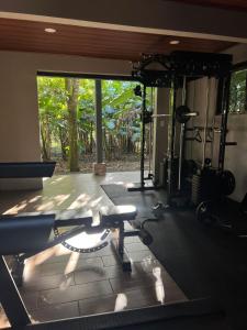 a room with a gym with a large window at Green Trails Miravalles in Bagaces