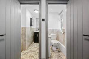 a bathroom with a toilet and a sink at The Reading Hub in Reading