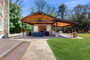 a pavilion with a table and chairs in a park at Game Day Hub < 1 Mi to Stadium & Patriot Place! in Foxborough