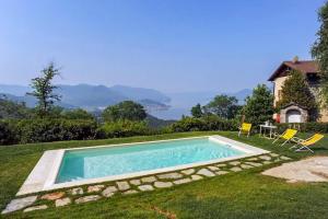 a swimming pool in the yard of a house at Villa Tirolese in Due Cossani