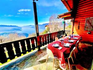 a table and chairs on a balcony with a view at Villa Tirolese in Due Cossani