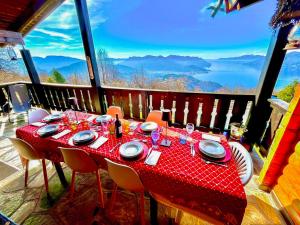 a table with a red table cloth on a balcony at Villa Tirolese in Due Cossani +39 photos