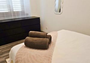 a bedroom with a bed with two towels on it at La Petit Clé - Centre Ville in Sélestat
