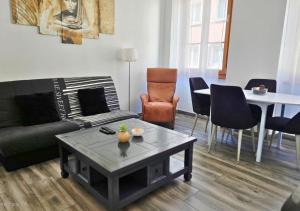 a living room with a couch and a table at La Petit Clé - Centre Ville in Sélestat