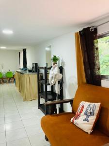a living room with a chair and a fan at Hotel Boutique D Angelo in Manzanillo