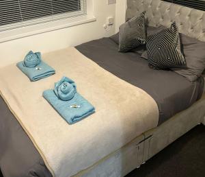 a bed with blue towels on top of it at Large 4 bedroom house for Contractors, Large groups or Retreat sleeps 8 people in Durham - NO Smoking Indoor House in Edmondsley +14 photos