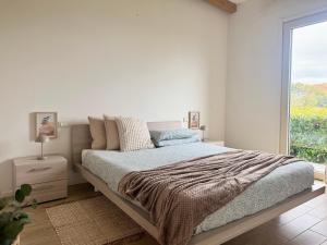 a bedroom with a bed and a large window at Respiro di Tramonto in Montegranaro +122 photos