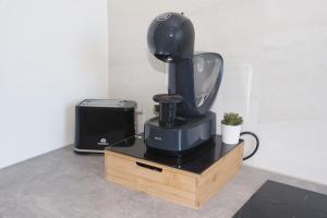 a black mixer sitting on a stand next to a printer at T4 Oasis tropicale x Nawassi in Pamandzi