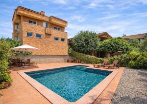 a swimming pool in front of a house at Nature & Tranquility only 25km from Barcelona in Torrelles de Llobregat