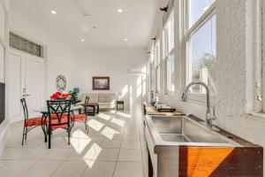 a kitchen with a sink and a table with chairs at Near Apollo Beach! Bright Apt w/ Essentials in Ruskin