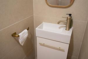 a bathroom with a white sink and a mirror at T4 Oasis tropicale x Nawassi in Pamandzi +37 photos