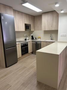 a large kitchen with a refrigerator and a counter at Lorenzo in Benaguacil +20 photos