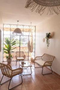 a room with chairs and a table and a window at T4 Oasis tropicale x Nawassi in Pamandzi