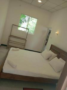 a bedroom with a bed with a ladder and a window at Serenity villa in Weligama