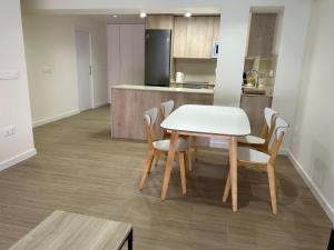 a kitchen with a table and chairs in a room at Lorenzo in Benaguacil