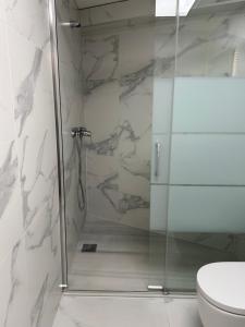 a shower with a glass door in a bathroom at Lorenzo in Benaguacil