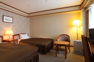 Ένα ή περισσότερα κρεβάτια σε δωμάτιο στο Hotel Viamare Kobe