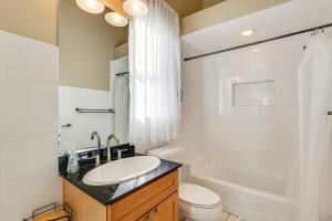 a bathroom with a sink and a toilet and a shower at Near Apollo Beach! Bright Apt w/ Essentials in Ruskin