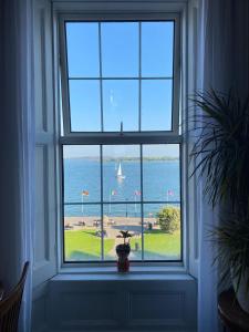 a window in a room with a view of the ocean at Anns Sea View Suite in Cobh