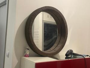 a mirror sitting on top of a dresser at Studio in Edgware