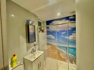 a bathroom with a shower and a toilet and a sink at Studio in Edgware