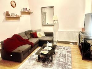 a living room with a couch and a table at Studio in Edgware
