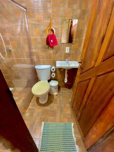 a small bathroom with a toilet and a sink at Pousada Da Bell in Barreirinhas