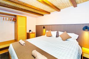 a bedroom with a large bed and a window at Palm Beach Resort in Serekunda