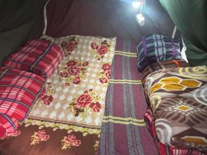 a bed with two pillows and a comforter at Kedar cloud camp in Kedārnāth