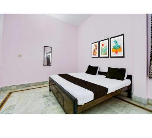 a bedroom with a bed in a room at Hotel Padamaa Palace in Varanasi