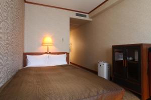 Ένα ή περισσότερα κρεβάτια σε δωμάτιο στο Hotel Viamare Kobe
