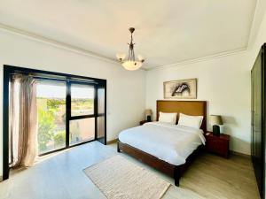 a bedroom with a bed and a large window at Atlantic View Duplex Tawenza Bay in Taghazout +55 photos